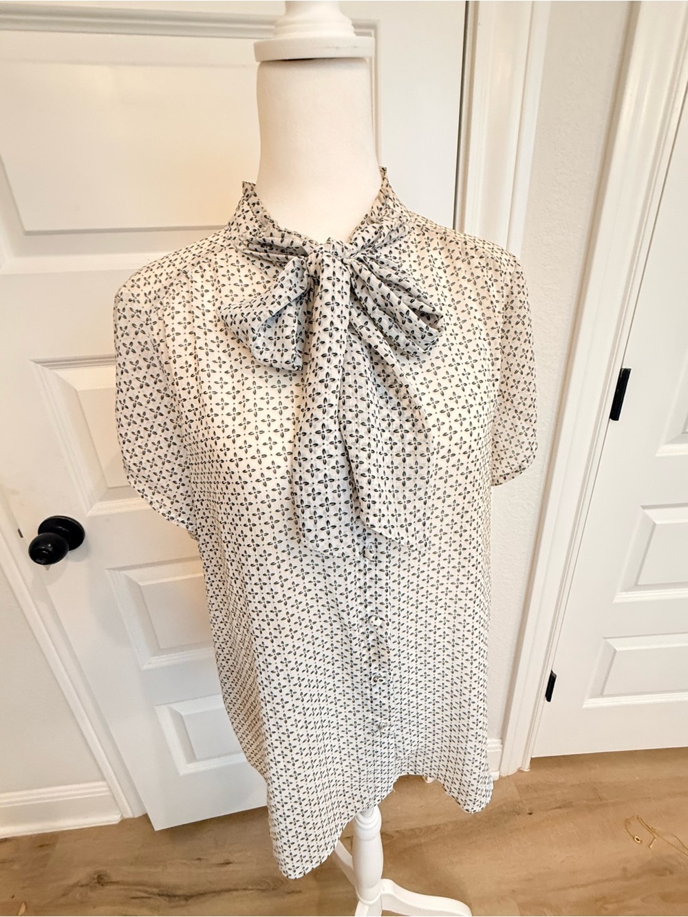 Pleione Ivory Tie-Neck Flutter Sleeve Blouse with Black Motif